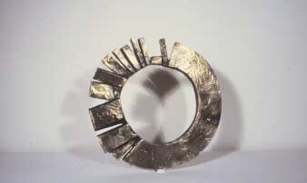 Formation of a Round Surface, 1986, bronze, 26 x 25.4 x 2.5 cm. Private collection